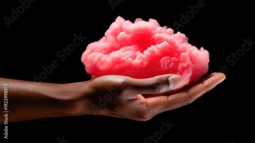 Pink cloud held gently in hand