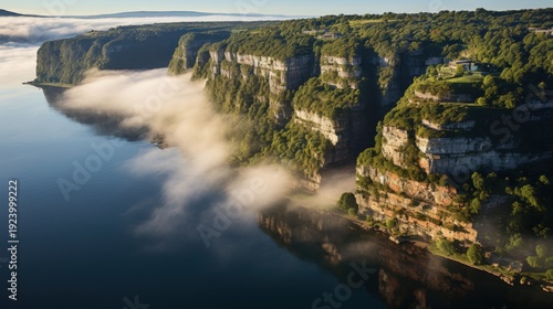 Dramatic cliffs shrouded in morning mist