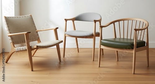 Three distinct mid-century modern wooden lounge chairs are displayed on a light hardwood floor in a minimalist interior.