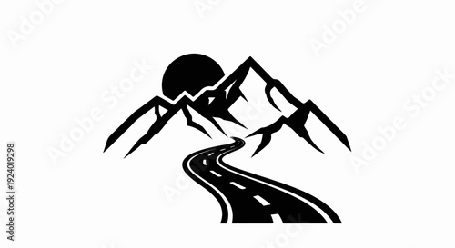 Winding road leads to majestic mountains under a setting sun