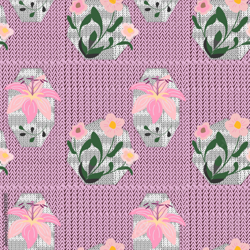  Hand-drawn primitive applique flowers with frayed edges sewn onto soft pink knitted background 