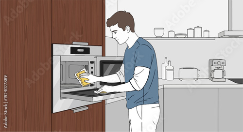 Young man cleaning kitchen appliance with yellow cloth and sponge