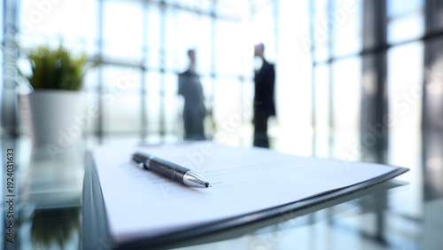 A pen is on top of a piece of paper