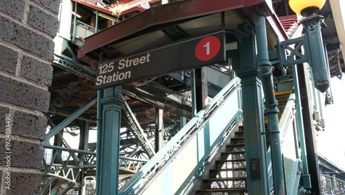 New York City 125 street elevated subway metro entrance in Harlem, United States. American passenger transport, Upper Manhattan. Metropolitan station in NYC USA. Historic architecture, metallic bridge