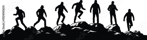 Silhouettes of people running and climbing on rocky terrain in black and white