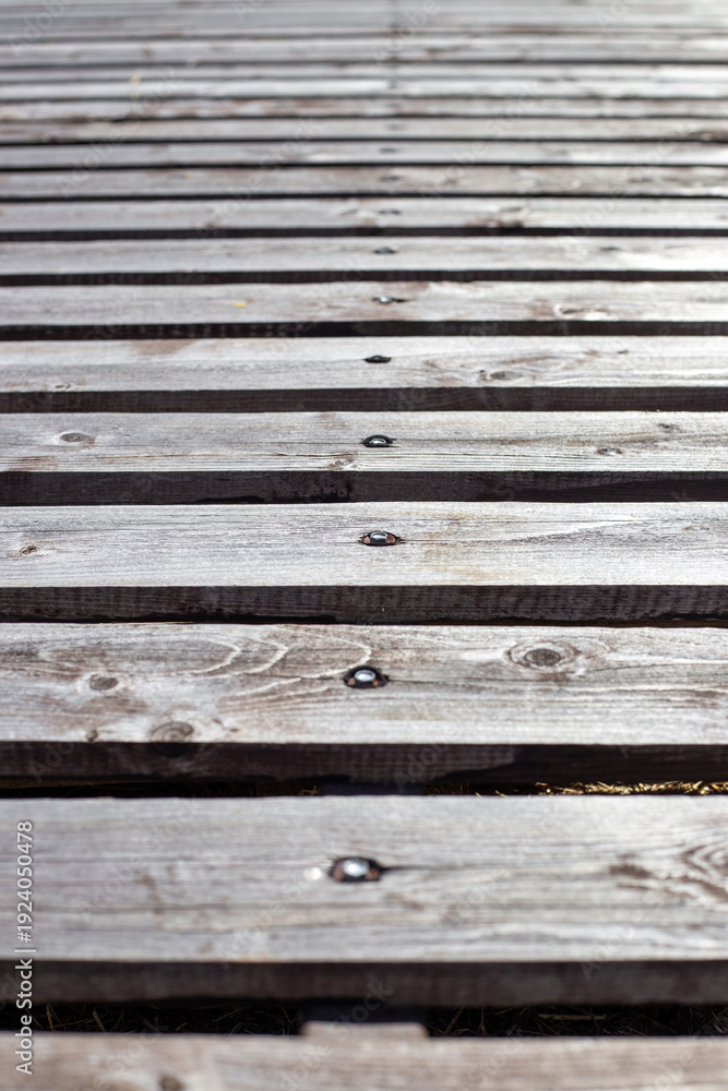 Obraz premium Vertical view of horizontal wooden planks with screws showing texture and grain. wood background, natural material, rustic surface.