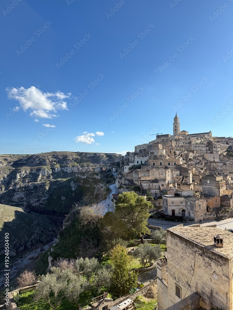 Fototapeta premium Carved into stone and shaped by centuries, Matera rises from the rocks of southern Italy like a timeless masterpiece.