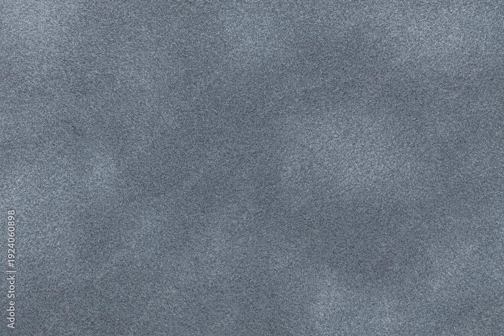 Fototapeta premium Gray suede fabric background with matte nap velvet texture. Graphite tones and soft felt textile surface in macro