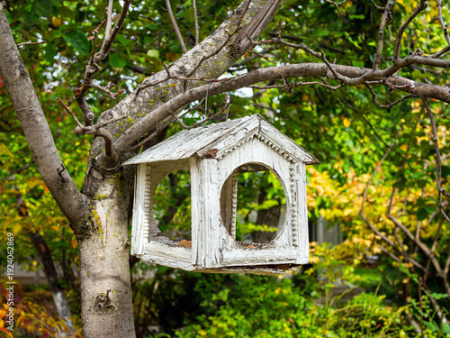 An old wooden bird feeder with carved ornamentation