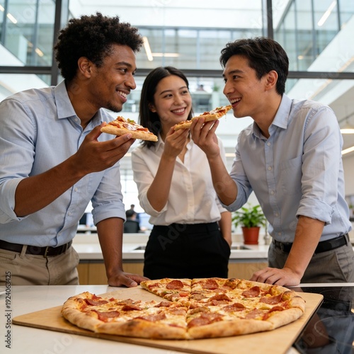 A group of colleagues having a pizza lunch in a modern office