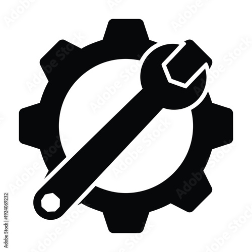 Close up of a metallic wrench tool resting diagonally across a large black gear mechanism symbolizing industry mechanics repair and mechanical engineering solutions in a clean