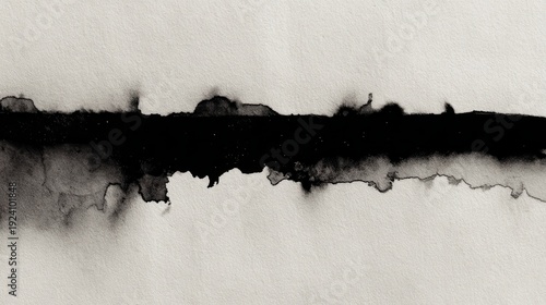 Black india ink bleeding edge, horizontal line of ink soaking into wet paper, monochromatic abstract texture