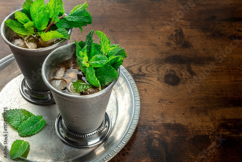 Mint Julep in the Kentucky Derby classic silver glass, with fresh , on a tray