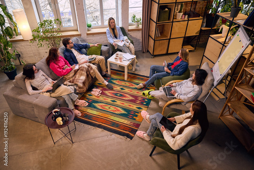 Фотография Overhead view of startup team brainstorming in loft workspace