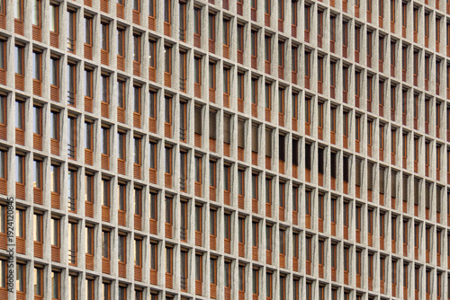 Rhythmic Modernist Facade of a Public Building in Oslo Norway Featuring a Modular Concrete Grid and Wooden Window Frame Detail