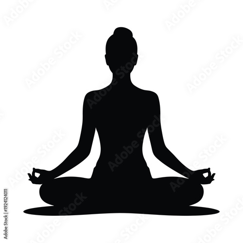 Silhouette of a woman practicing yoga in a meditative pose