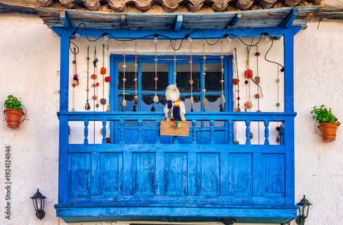 Colonial style building with a wooden vibrant painted blue balcony in San Blas artisan neighborhood of Cusco