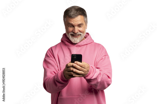 Smiling mature man wearing pink sweatshirt looking at smartphone, isolated on transparent