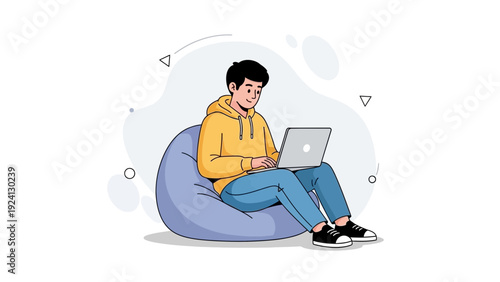 Young man working on laptop while sitting on bean bag chair, casual lifestyle