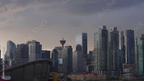 Wallpaper Mural Calgary cityscape showcasing modern skyscrapers and the Calgary Tower under a cloudy sunset sky Torontodigital.ca