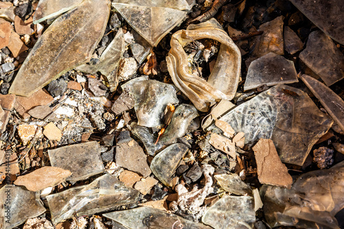 The broken and melted glass scattered along the floor of the ruin of the museum at Ngwenja mine in Eswatini