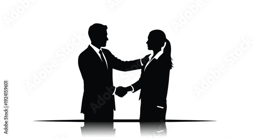 Silhouette of business people shaking hands in agreement.