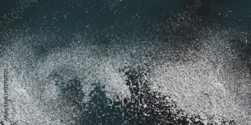 Flour spilling on black background. Abstract design of white powder cloud. Abstract wallpaper design of white color shiny snow dust powder isolated on black background .


