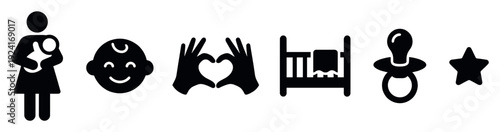 Set of black baby and motherhood icons featuring a mother with child, smiling face, heart hands, crib, pacifier, and star in a simple, flat graphic silhouette style