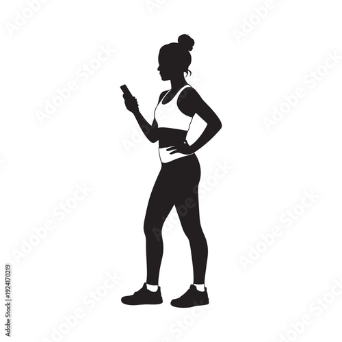 Silhouette of a woman using a smartphone while wearing athletic apparel