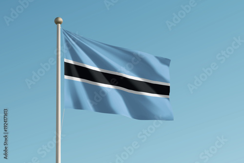 Botswana national flag waving on pole against clear blue sky background.
