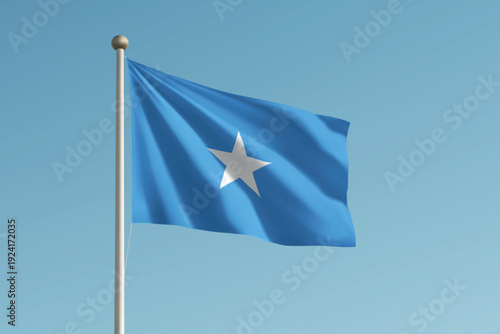 Somalia national flag waving on pole against clear blue sky background.