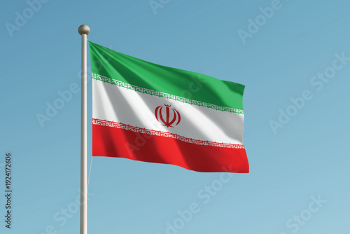 Iran national flag waving on pole against clear blue sky background.