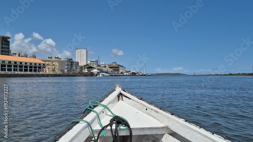 A boat heads towards the historic center of Recife, Brazil