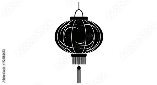Black wireframe lantern hanging from a thin wire against a.