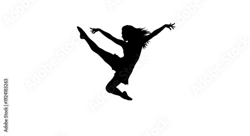 Young girl dancing with her leg raised in a joyful leap.