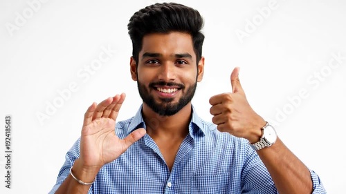 Smiling man with dark hair and beard giving thumbs up isolated on white background
