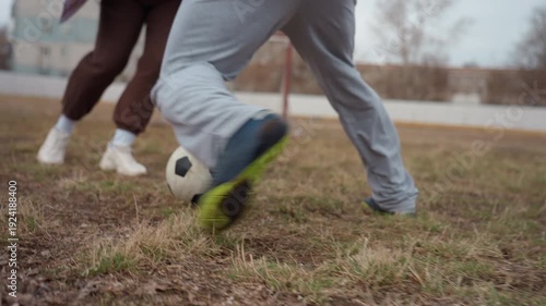 wet field footwear in action, moist ground with splashing shoes displaying vigorous athletic activity, damp turf emphasizes muddy footwear movement capturing energetic moments on field