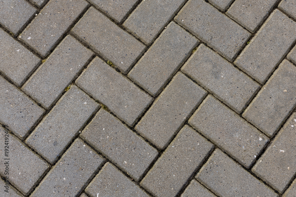 Foto Grey herringbone interlocking paving brick background texture