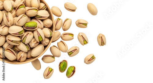 Pistachios spilling out of a bowl onto a white surface with some shells open isolated on transparent background