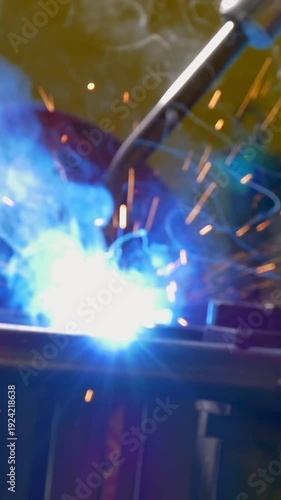 A modern industrial robot masterfully joins metal pipes in a factory. Bright sparks fly and molten metal glows under the intense argon welding arc.