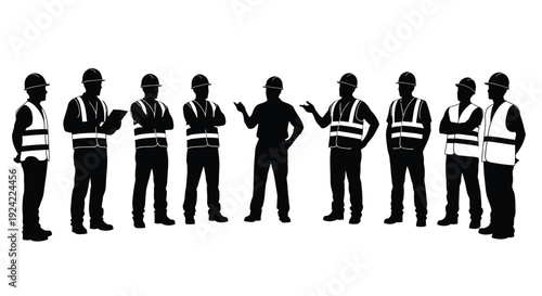 Silhouette of construction workers in high visibility vests standing together
