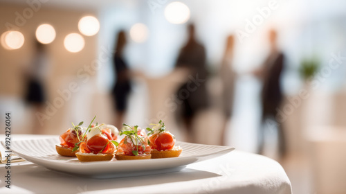 Gourmet canapes served at a sophisticated event with blurred guests in background. Elegant appetizers featuring fresh ingredients are presented on white plate, ready for guests at catered gathering