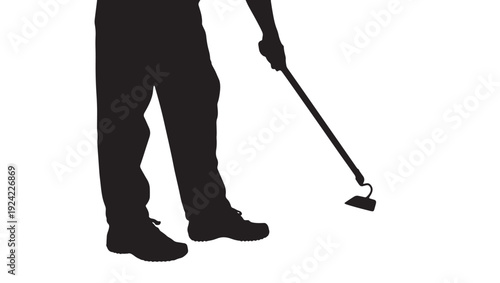 Gardener silhouette holding long-handled hoe tool, standing figure in work boots, isolated black cutout on white background for farming and landscaping design