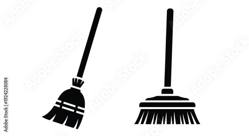 Two black brooms stand against a white background a simple silhouette