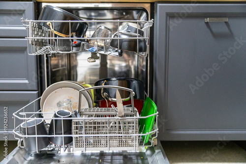 Tableau sur toile Dirty dish in open integrated dishwasher