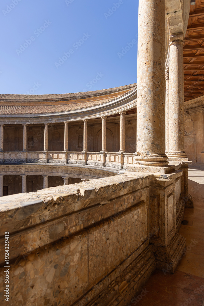 Fototapeta premium Granada, Spain, Andalusia - March 23, 2025: Circular patio of Palace of Charles V, renaissance building inside fortress Alhambra, former Nasrid palace complex