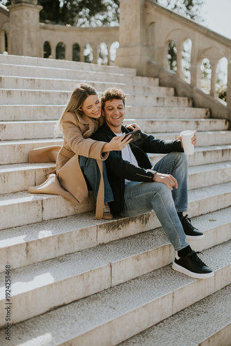 Couple sitting on stairs in...