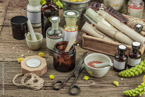 Rustic apothecary scene with Verbascum flowers, herbal jars, vintage tools and mortar