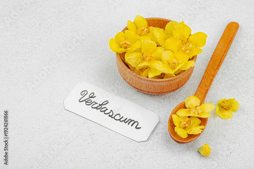 Fresh Verbascum flowers in a small jar with name tag. Alternative medicine