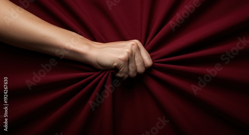 Closeup of Hand Gripping Red Fabric with Dramatic Folds – Passion, Desire, Strength, Sensual Tension, Power and Emotional Intensity Concept on Dark Red Background